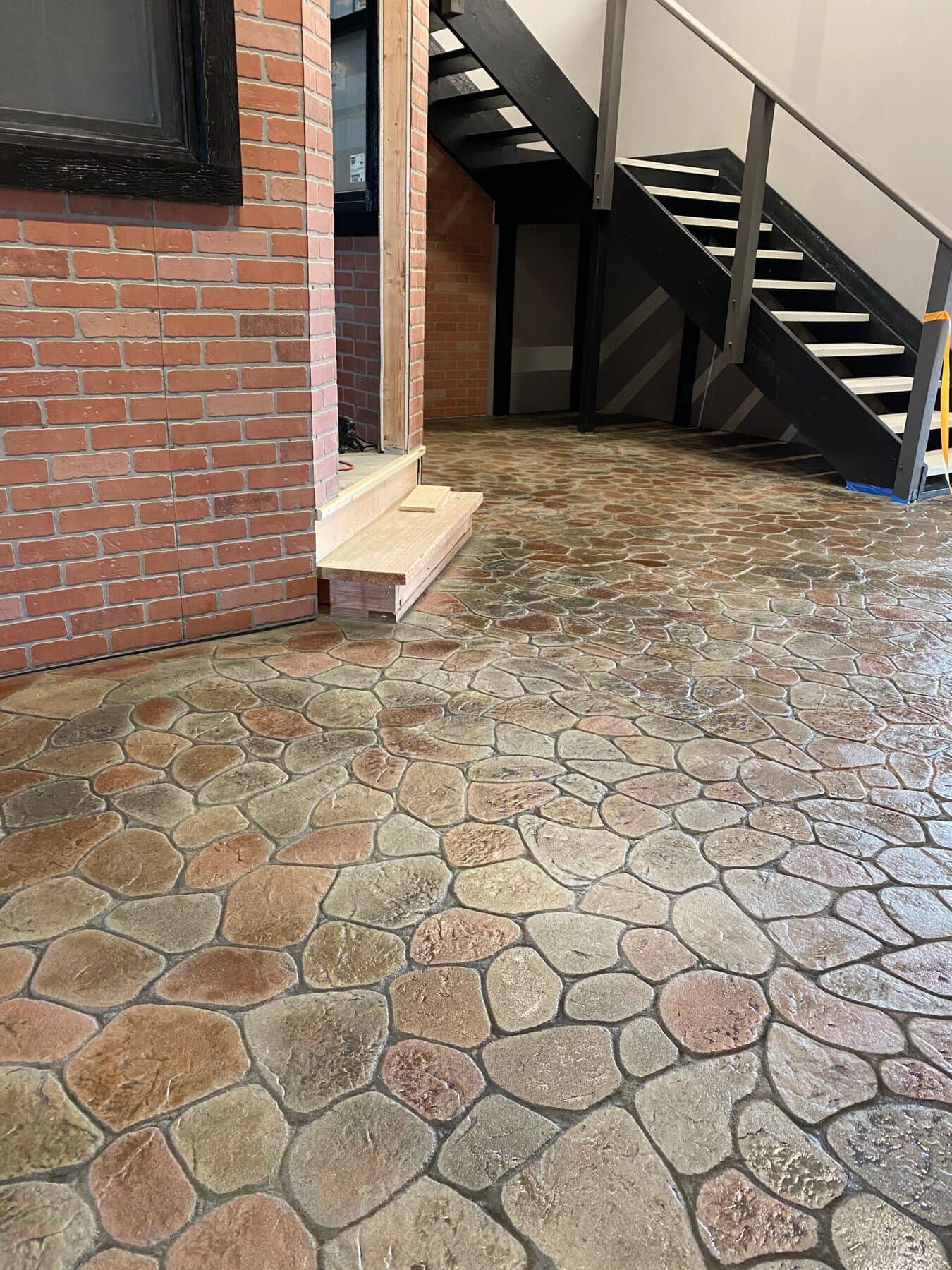 Multicolor flagstone patio beside a brick column