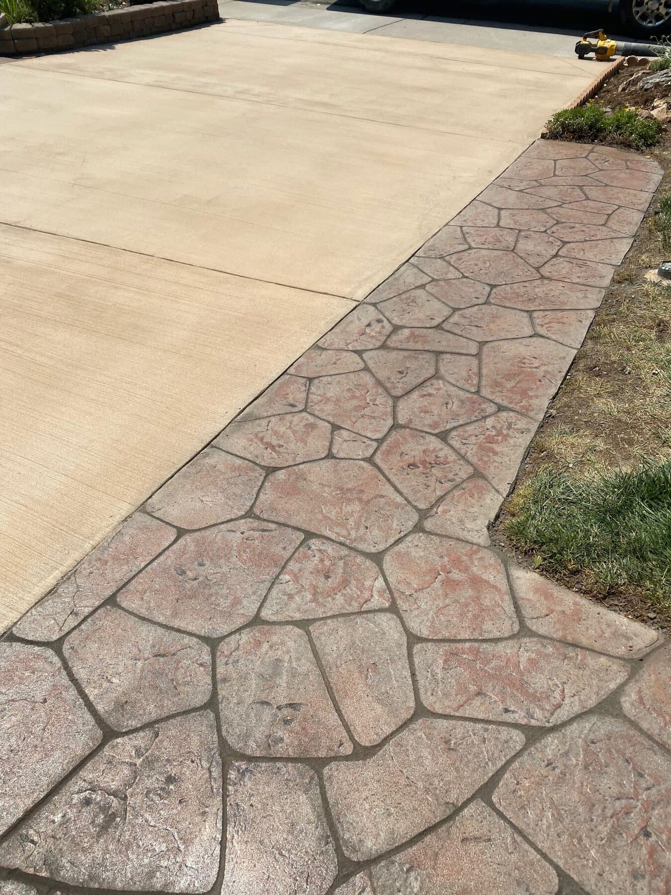 Flagstone walkway inlaid into a tinted driveway